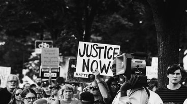 a group of people holding signs saying 'justice'
